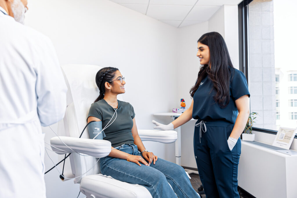 A patient sits in a treatment chair and discusses treatment options with a blood pressure doctor in Vienna.